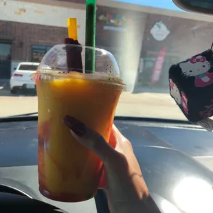 a person holding a drink in their hand