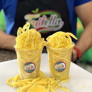 two cups of fries on a table