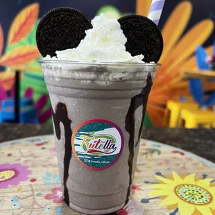 a milkshake with oreo cookies and whipped cream