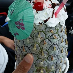 a person holding a pineapple cake