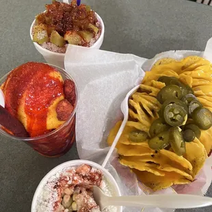 Mangonada, corn in a cup, nachos, the other is chamoyada with pickles
