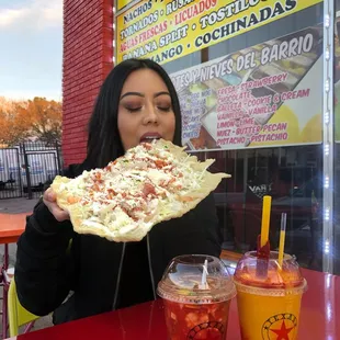 a woman eating a slice of pizza