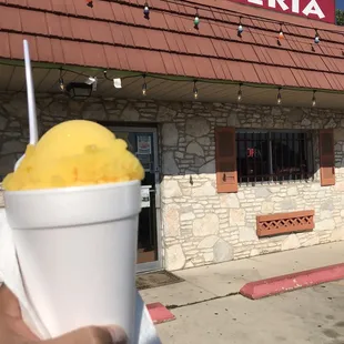  a hand holding a cup of ice cream