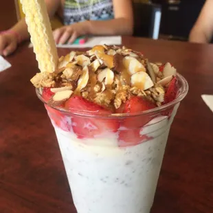 Mitotero! Almonds and cream with granola fresh strawberries, large vanilla ice cream scoop.