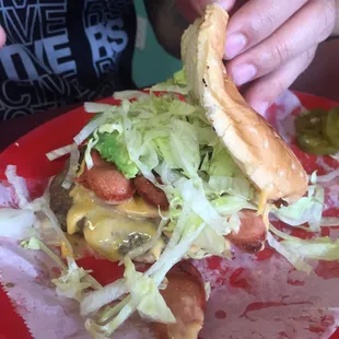 Hamburger with ham, cheese and sliced hot dog.