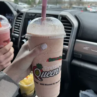 a person holding a drink in a car