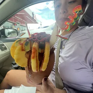 a woman in a car holding a chocolate sundae