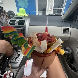 a person in a car holding a bowl of food