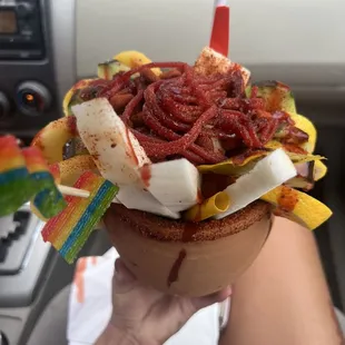 a person holding a bowl of food