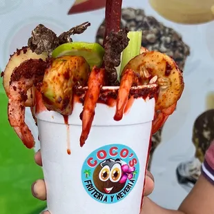 a person holding a cup of food