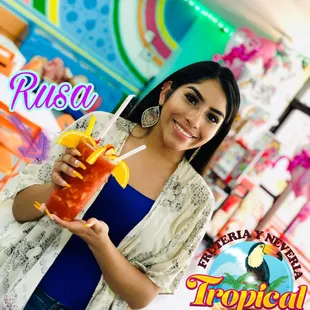 a woman holding a drink