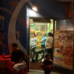 people sitting at tables in a restaurant