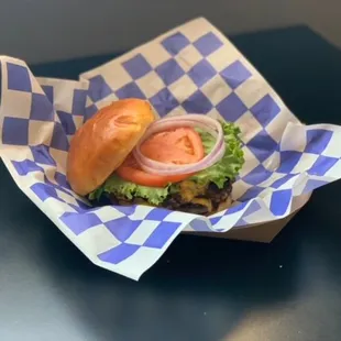 a hamburger with lettuce and tomato