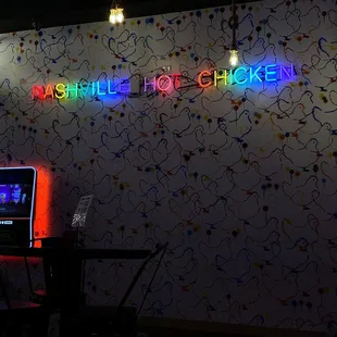 a neon sign that says nashville hot chicken