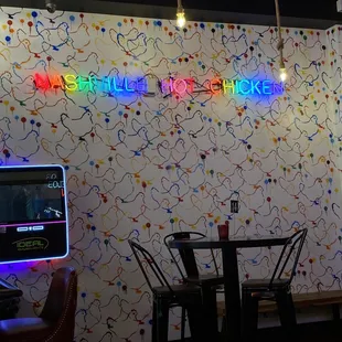 a neon sign on the wall