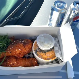 a box of fried chicken and a can of soda