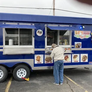 a man ordering food from a food truck