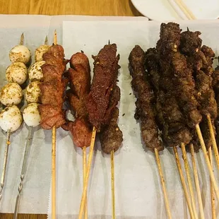 a variety of skewered meats