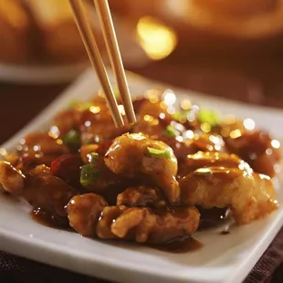 a plate of food with chopsticks