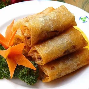 a plate of chinese food with carrots and broccoli