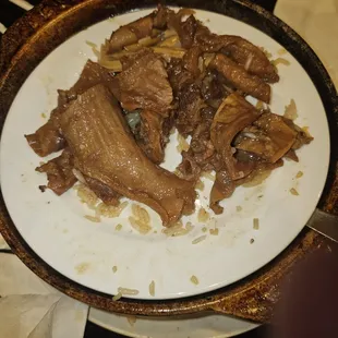 Fat and gristle from short rib clay pot meal.  Very little edible meat for $18. No apology or discount. That is a 12" dinner plate.