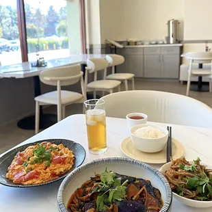 two plates of food and a glass of beer