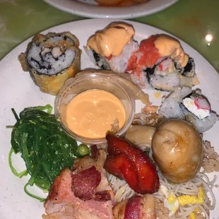 a plate of sushi and rolls