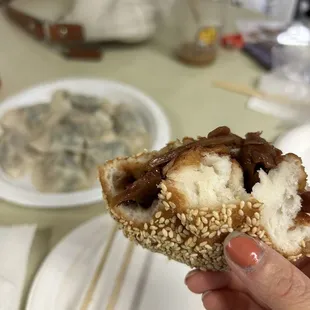 a person holding a piece of food