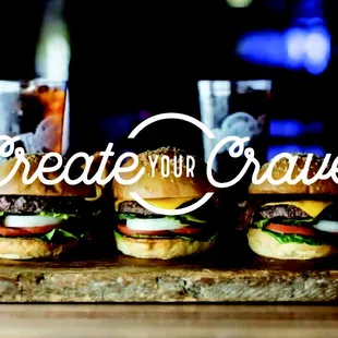 burgers on a cutting board with the words create your craver