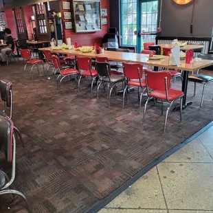 a dining area with tables and chairs