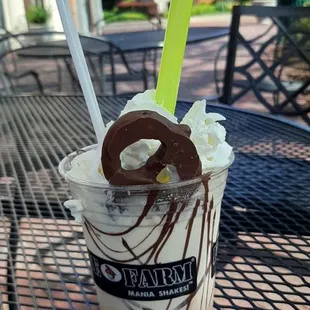 a chocolate milkshake with whipped cream and chocolate sprinkles