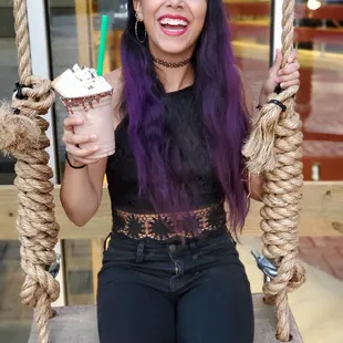 Enjoying my chocolate banana milkshake topped with a piece of cheesecake!