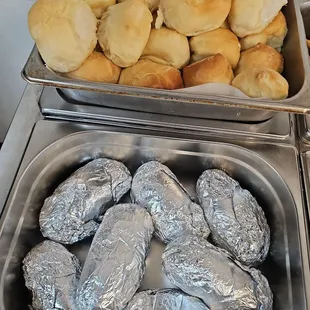 Baked potatoes &amp; rolls on lunch buffet