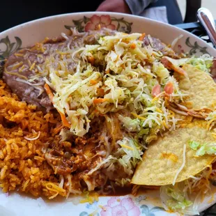 Taco/Enchilada combo with rice and beans, solid &apos;B&apos; grade.