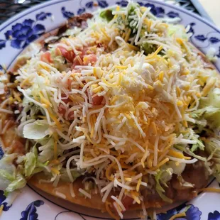 The pollo (Shredded Chicken) tostada, size is medium, solid &apos;B&apos; grade