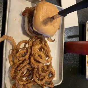 a plate of onion rings and a burger