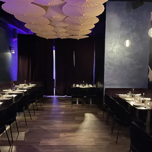 a dining area with tables, chairs, and umbrellas