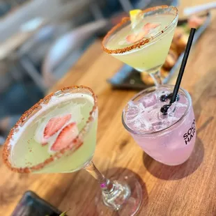 three cocktails on a table