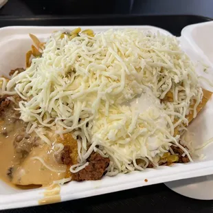 Chorizo Nachos with toppings .