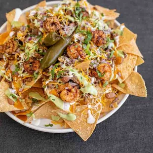 Surf and Turf Nachos. Which consiste of chuck steak with blackened shrimp. Nachos are made fresh daily!
