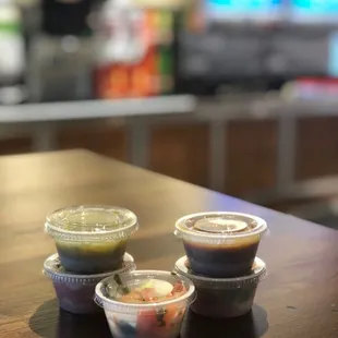 Salsas are ready to go while patiently waiting for my take-out order!