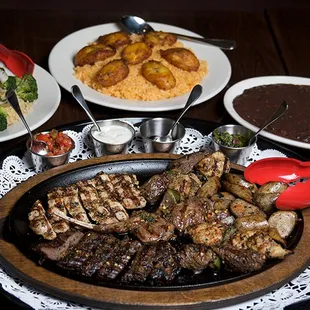 Uruguayan Grass Fed Ribeye, Chicken Skewer, Spicy Beef &amp; Veal Sausage, Dark Meat Chicken Parillada, (3) Latin Sides + (2) Side Selections