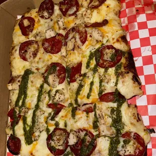 Sicilian garlic chicken Alfredo with pepperoni, half pesto drizzle half spicy honey drizzle