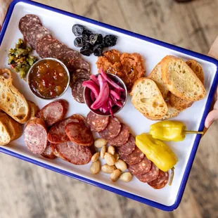 Charcuterie Plate: Assorted Meats from Gagliano&apos;s and Cheeses from Springside, featuring Farm Fresh Pickles and Jams.