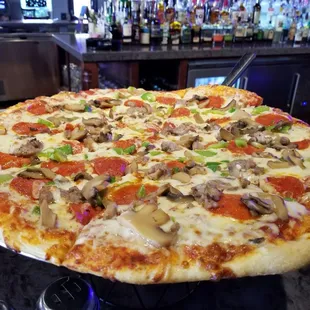 a pizza with mushrooms and peppers