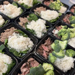 a tray of meat and broccoli