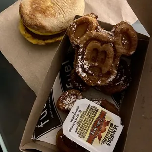 a box of donuts and a sandwich