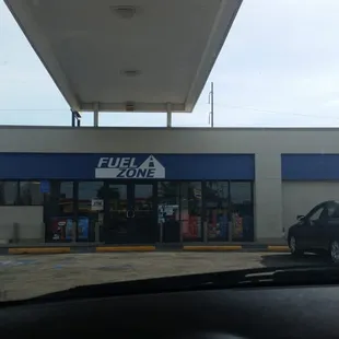 a car parked in front of a gas station