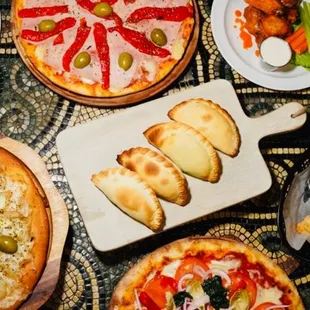 Serving a variety of pizza, empanadas and other items like wings and salads.