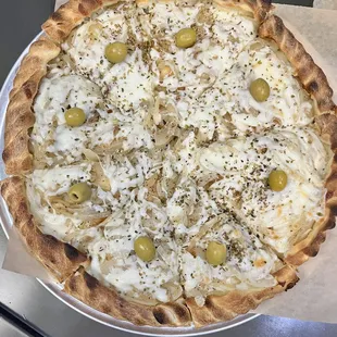 Stuffed Fugazzeta. Housemade dough stuffed with cheese and ham, then another layer of fresh dough topped with sauteed onions and cheese.